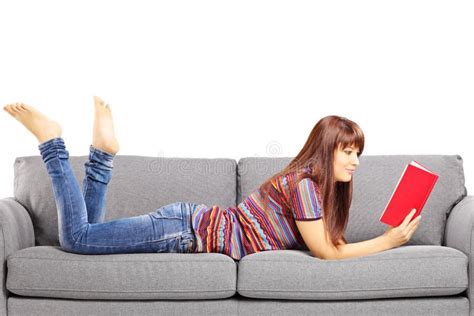 Young Female Lying On A Sofa And Reading A Book Stock Image Image Of Cheerful Background