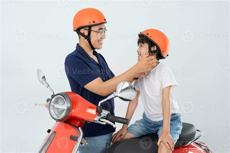 Father And Son Wearing Helmets And Riding Motorbikes Stock