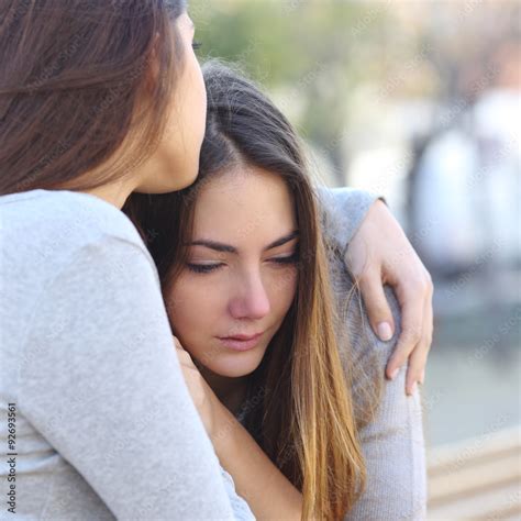 Sad girl crying and a friend comforting her Stock Photo | Adobe Stock