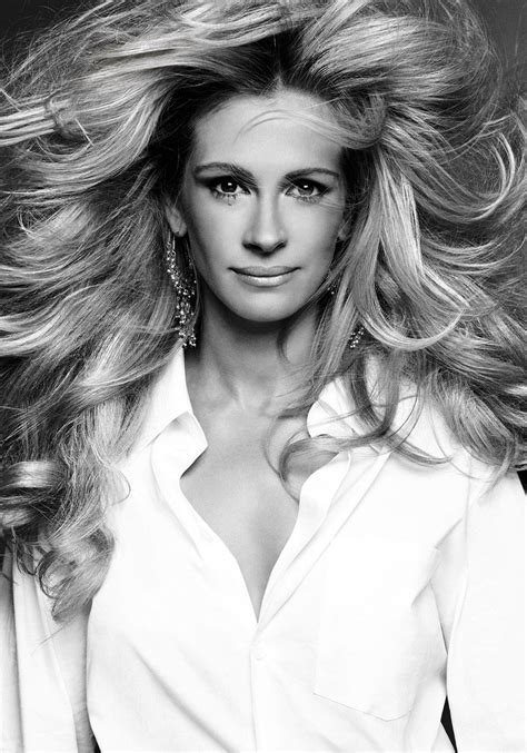 A Black And White Photo Of A Woman With Long Blonde Hair Wearing A Shirt