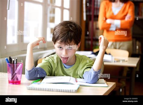 8 year old boy misbehaving at school Stock Photo - Alamy