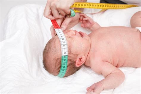 Newborn Medical Exam Doctor Checking Chest Size With A Measurement