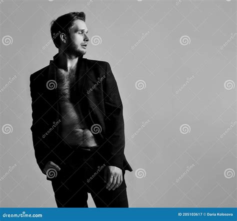 Black And White Photo Of Man In Black Classic Suit On Naked Body Stock