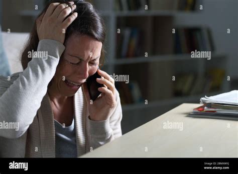 Sad Middle Age Woman Crying Calling On Smart Phone Sitting On The Floor