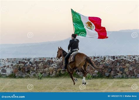 A Very Handsome Mexican Charro Poses In Front Of A Hacienda In The