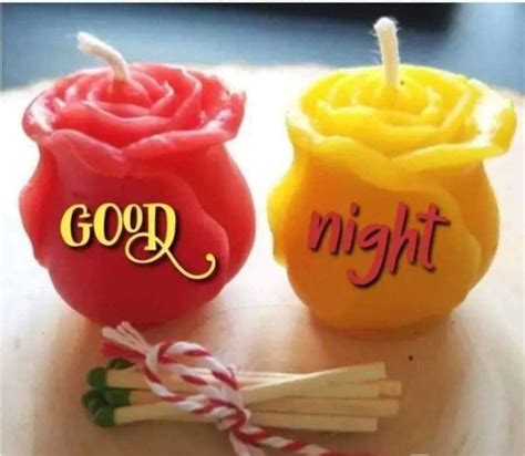 Two Candles Sitting On Top Of A Table With The Words Good Night Written