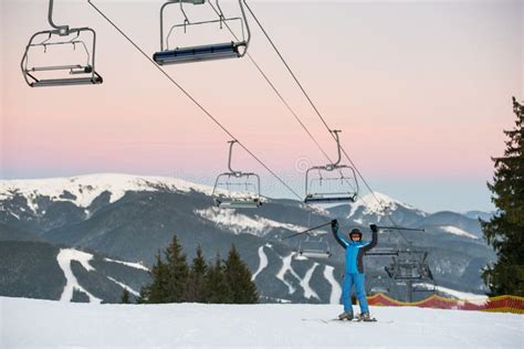 Skier Woman In Bikini And Snowboarder Man With Bare Torso On Background Of Snowy Mountains