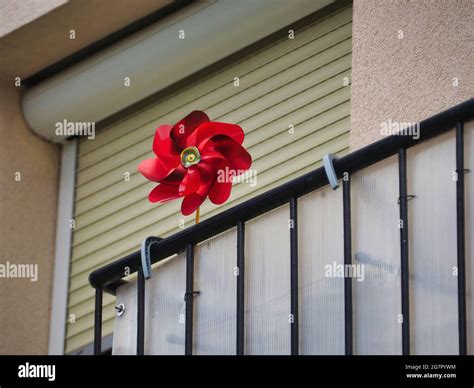 Low Angle Shot Of A Red Pinwheel In A Balcony Stock Photo Alamy