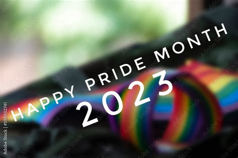 Happy Pride Month 2023 With Blurred Rainbow Wristband And Flag Background Concept For Lgbt