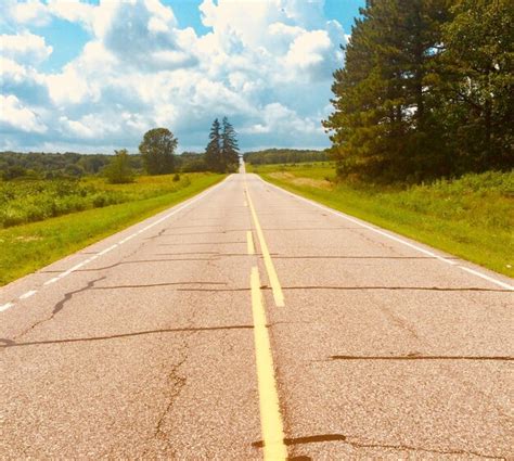 Premium Photo Empty Road Amidst Trees Against Sky