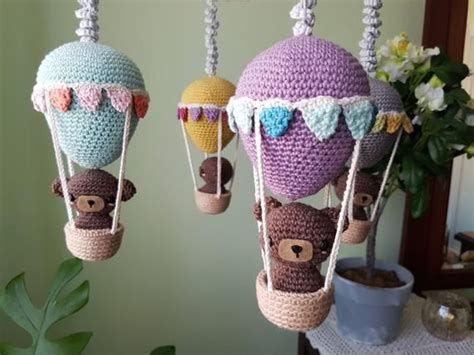 Three Crocheted Hot Air Balloons With Bears Hanging From The Top And