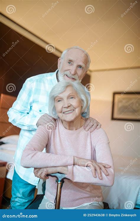 Two Senior People Smiling And Looking Happy Together Stock Photo