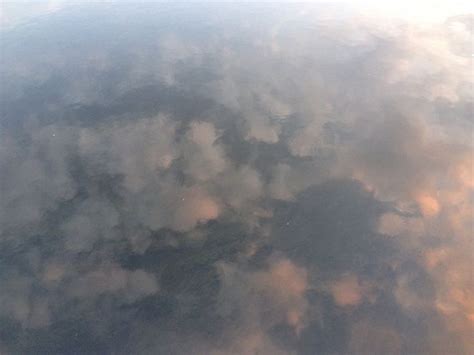 The Sky Is Reflected In The Water And It Looks Like Clouds Are Floating