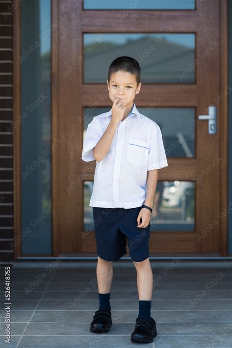 Handsome boys in school uniform leave home for their first day of ...