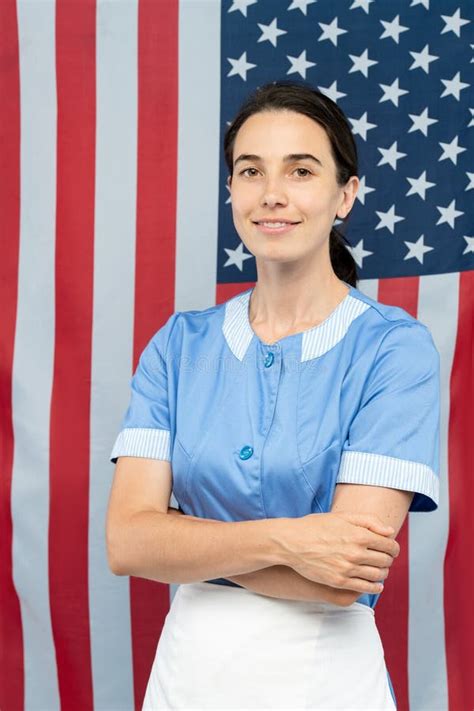 Young Confident Chambermaid In Blue Uniform Crossing Her Arms By Chest