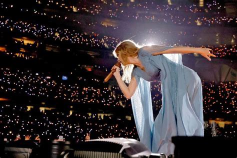 a woman is performing on stage in front of an audience