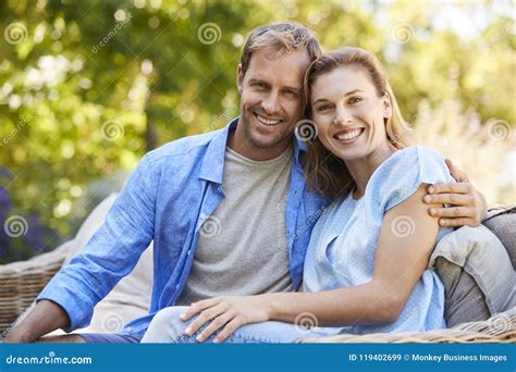 Happy Young White Couple Sitting and Embracing in the Garden Stock Image - Image of space ...