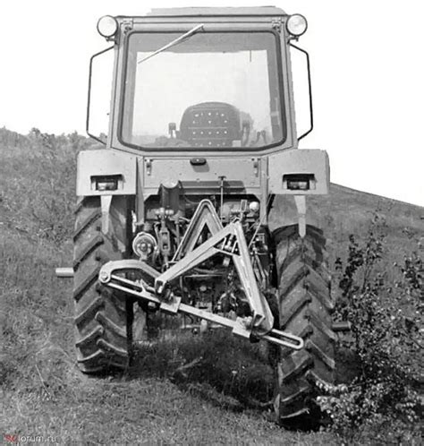 An Old Tractor Is Parked On The Side Of A Hill In Black And White Photo