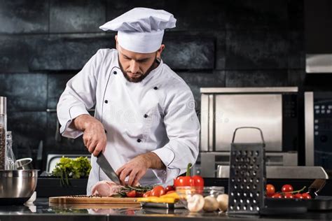 Chef Cutting Meat at Kitchen. Chef in Uniform Cut Beef at Planked Stock ...