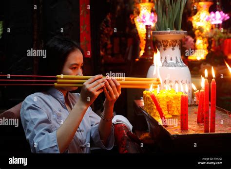 The Jade Emperor Pagoda Vietnamese Woman Praying With Incense Sticks