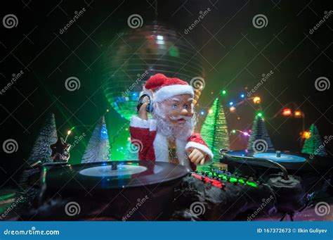 Dj Mixer With Headphones On Dark Nightclub Background With Christmas