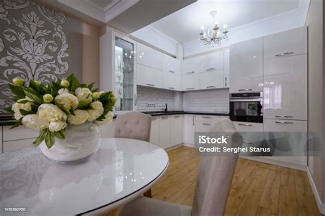 Luxury White Modern Kitchen With Dining Table Stock Photo - Download ...