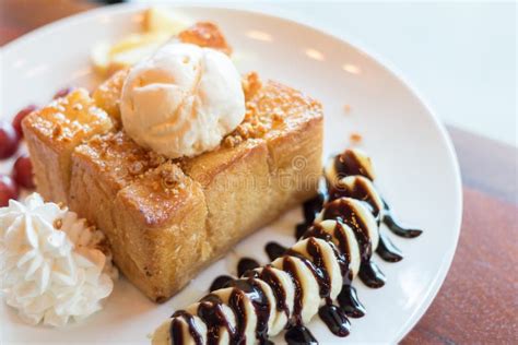 Honey Toast With Vanilla Ice Cream Whipped Cream And Chocolate Syrup