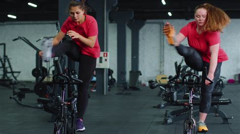 Athletic women group riding on spinning stationary bike training