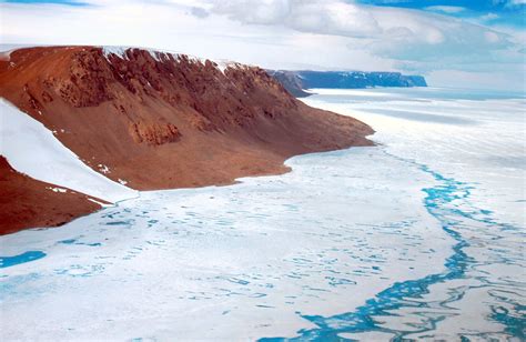 an aerial view of the ice and water in the arctic with snow on the ground