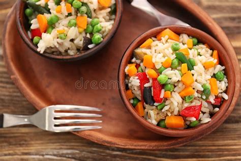 Tasty Boiled Rice with Vegetables in Bowls on Wooden Table Stock Image ...