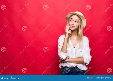 Portrait Of Young Blonde Woman Wearing In Straw Hat And Touching Chin