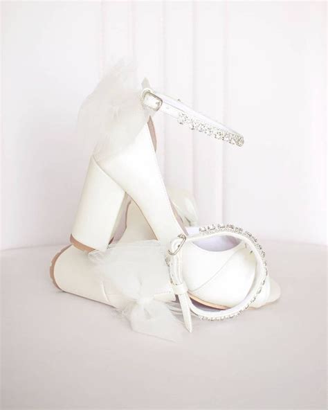 A White Bridal Shoe On Top Of A Table