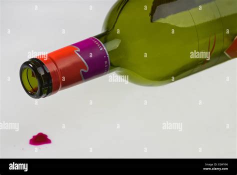 Empty Wine Bottle Lying On It S Side A Drip Of Red Wine On The Floor