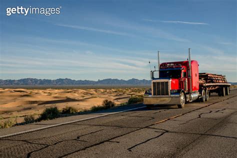 Long Haul Semi Truck Speeding Down A Four Lane Highway To Delivery