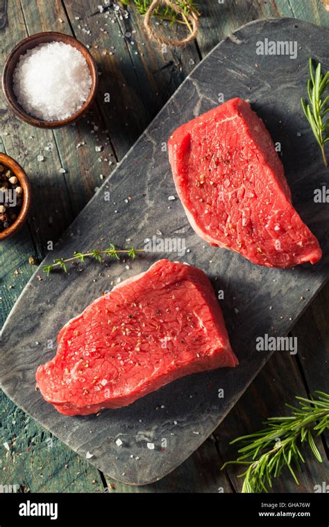 Raw Organic Grass Fed Sirloin Steak With Salt And Pepper Stock Photo