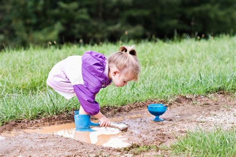 Child Playing In Mud Puddle Stock Photo - Image of bowl, boots: 11118354