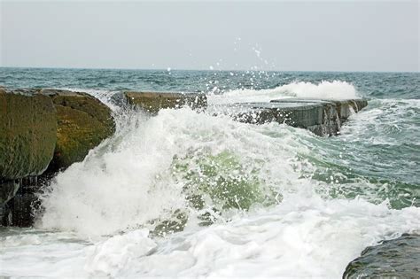 Wave Crashing Against the Breakwater Stock Image - Image of line ...