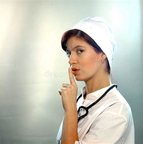 Woman In White Robe Showing Hush Sign Gesture With Hand Isolated On