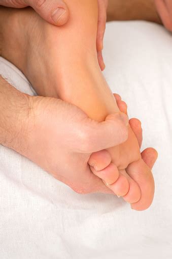 Relaxing Double Massage On The Female Foot By Two Masseurs In Spa Salon