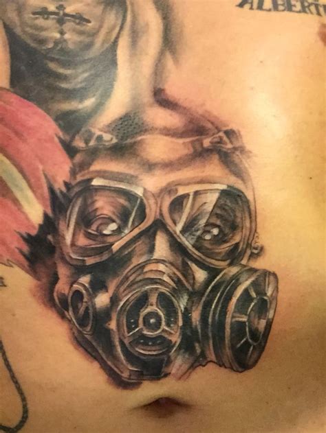 A Man With Gas Mask Tattoo On His Chest