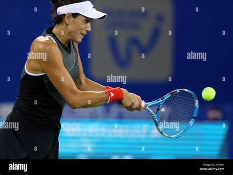 Garbine Muguruza Of Spain Returns A Shot To Magda Linette Of Poland In