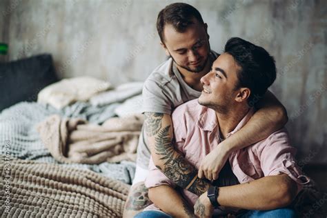 Stockfoto Two Sexy Blue Guys Enjoying Being Together Hugging Each Other Tenderly Lying On Bed