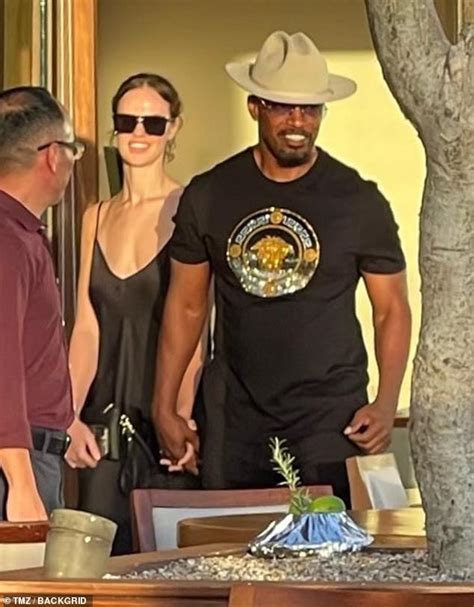 Jamie Foxx looks delighted as he holds hands with glamorous girlfriend ...