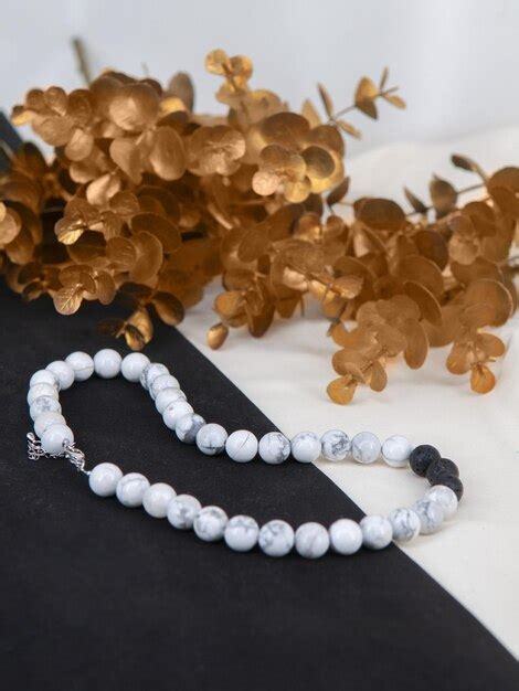premium photo jewelry   white natural stone  golden plants