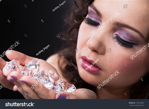 Portrait Of Young Beautiful Woman Holding Diamonds Stock Photo