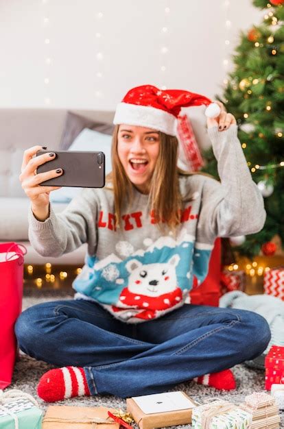 Free Photo Excited Woman Taking Selfie With Christmas Hat