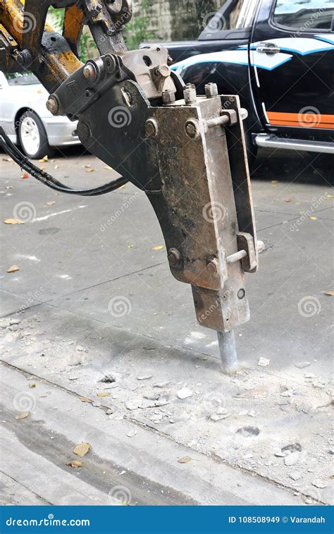 Drilling The Concrete Road By Excavator Digging Machine Stock Image