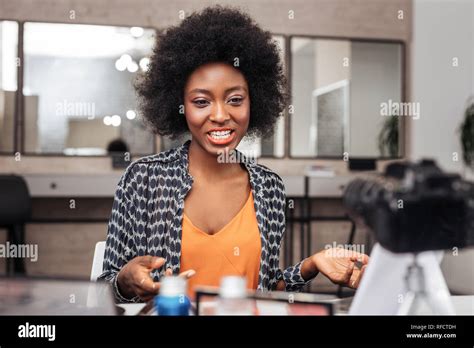 Beautiful African American Woman With Curly Hair Showing A Brush For