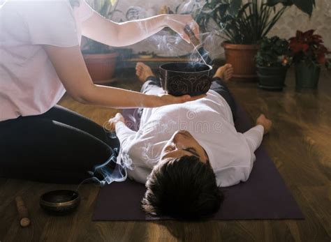 Woman Making Relaxing Massage For Young Man Meditation Sound Therapy