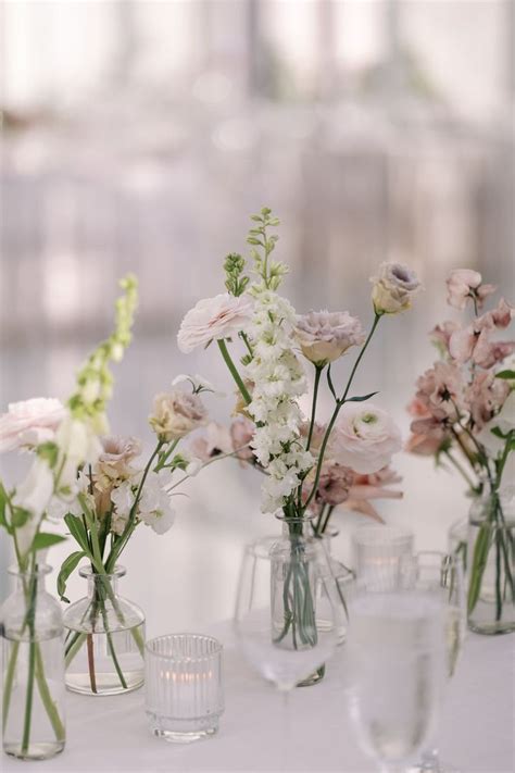 Several Vases Filled With Different Types Of Flowers On A White